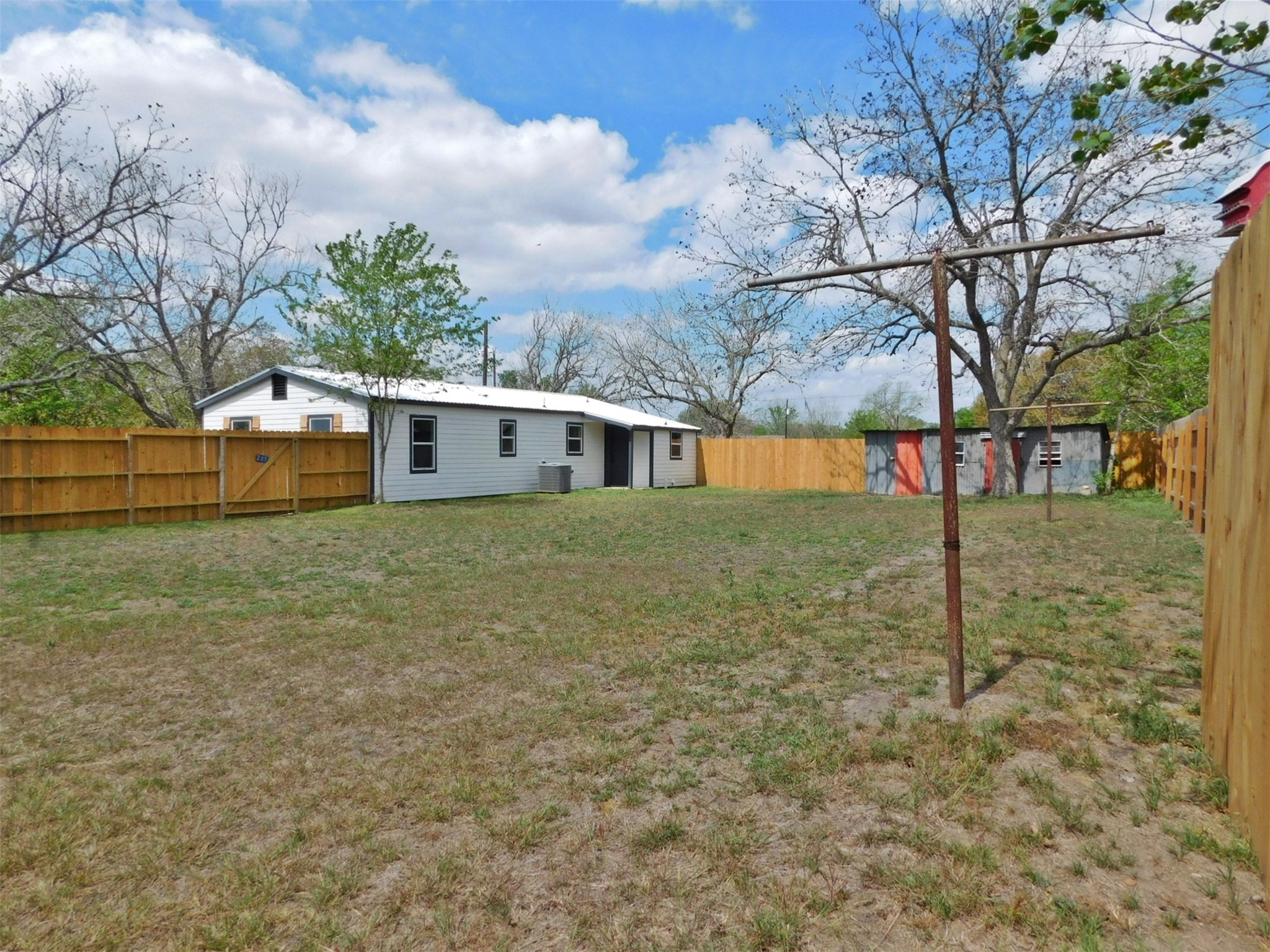 205 East Train Street Ellinger, TX 78938 - Photo 24 of 27 a white house that has tree in front of it