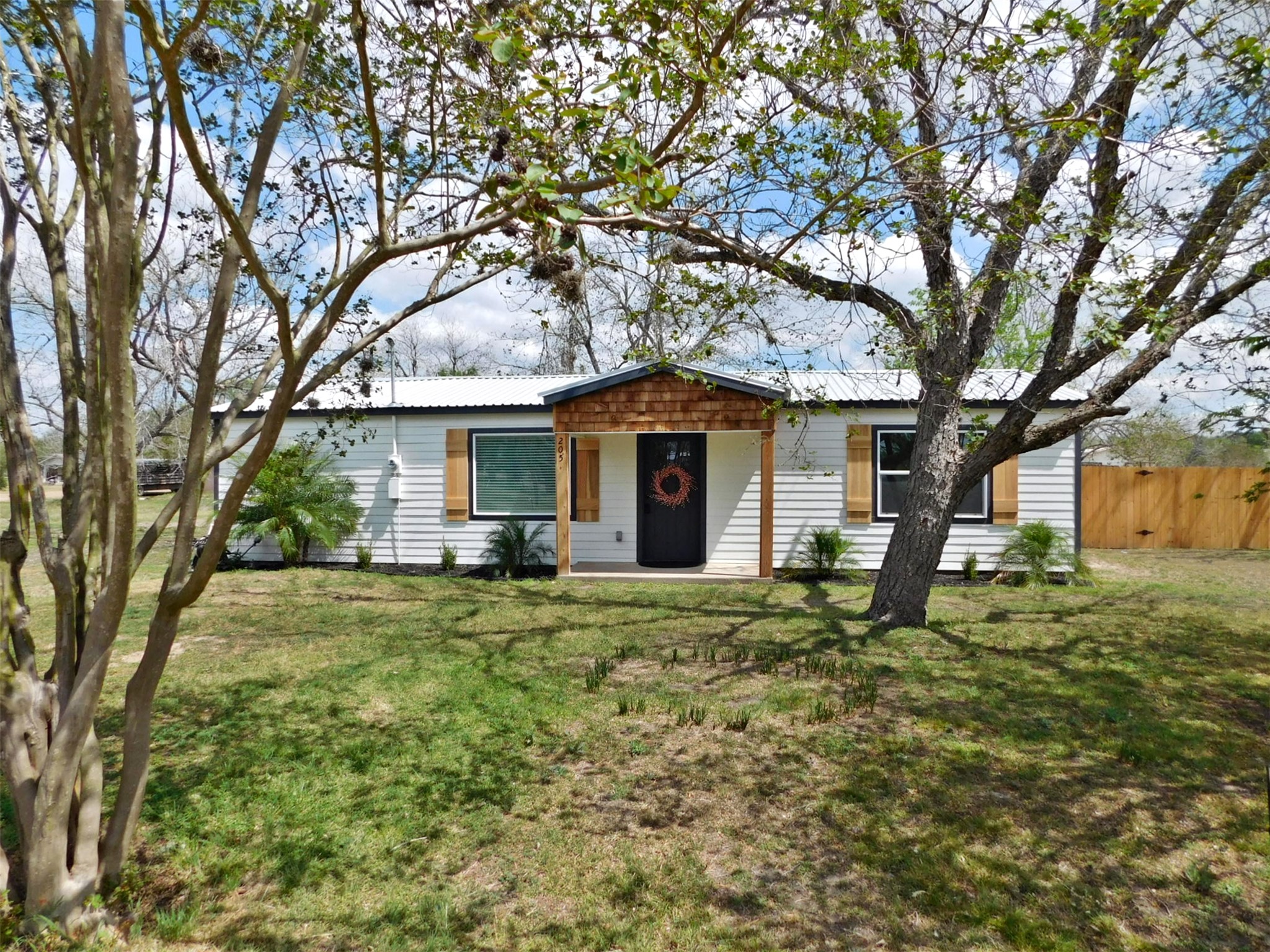 205 East Train Street Ellinger, TX 78938 - Photo 26 of 27 a front view of a house with garden