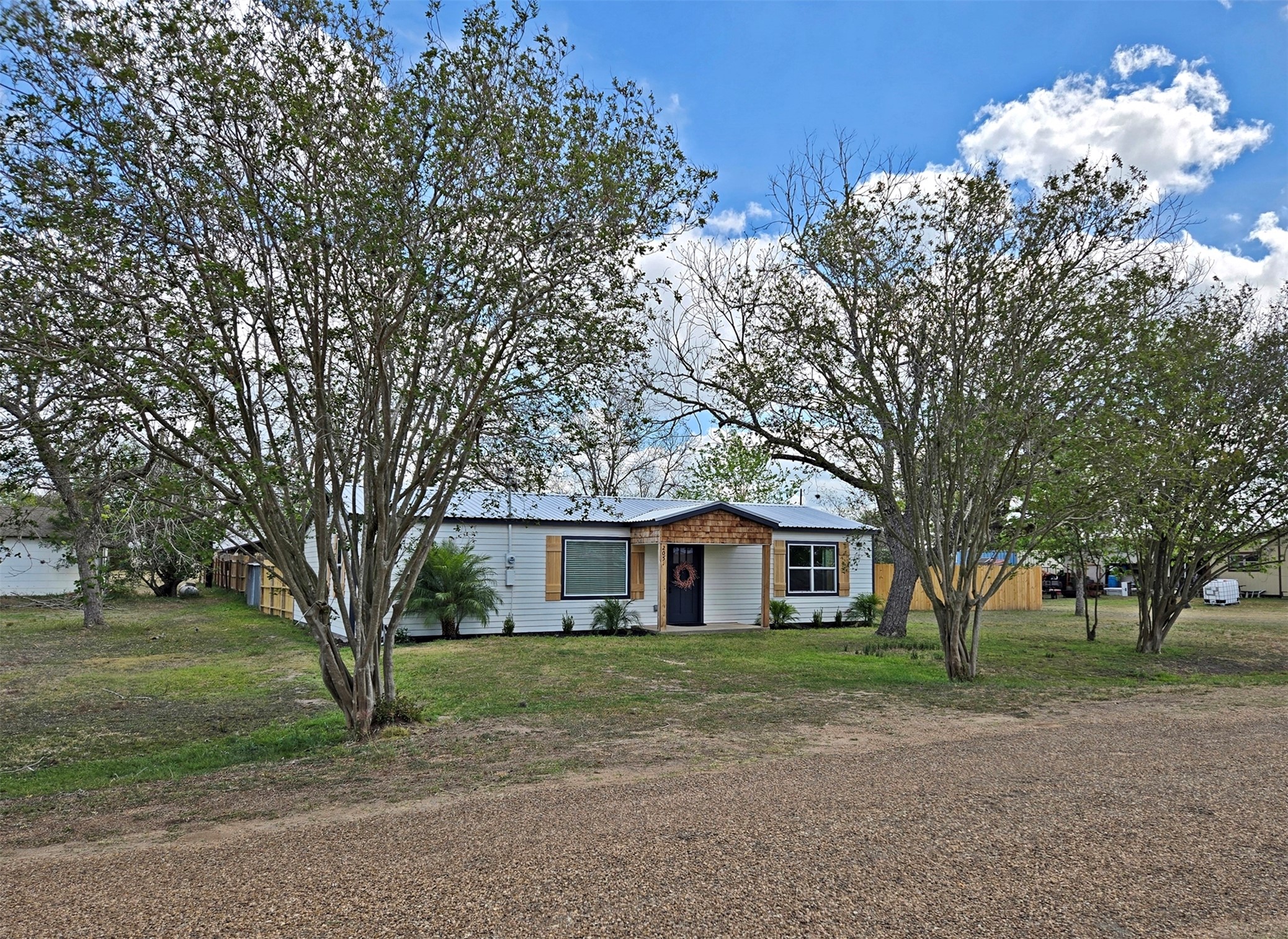 205 East Train Street Ellinger, TX 78938 - Photo 27 of 27 a front view of a house with a tree