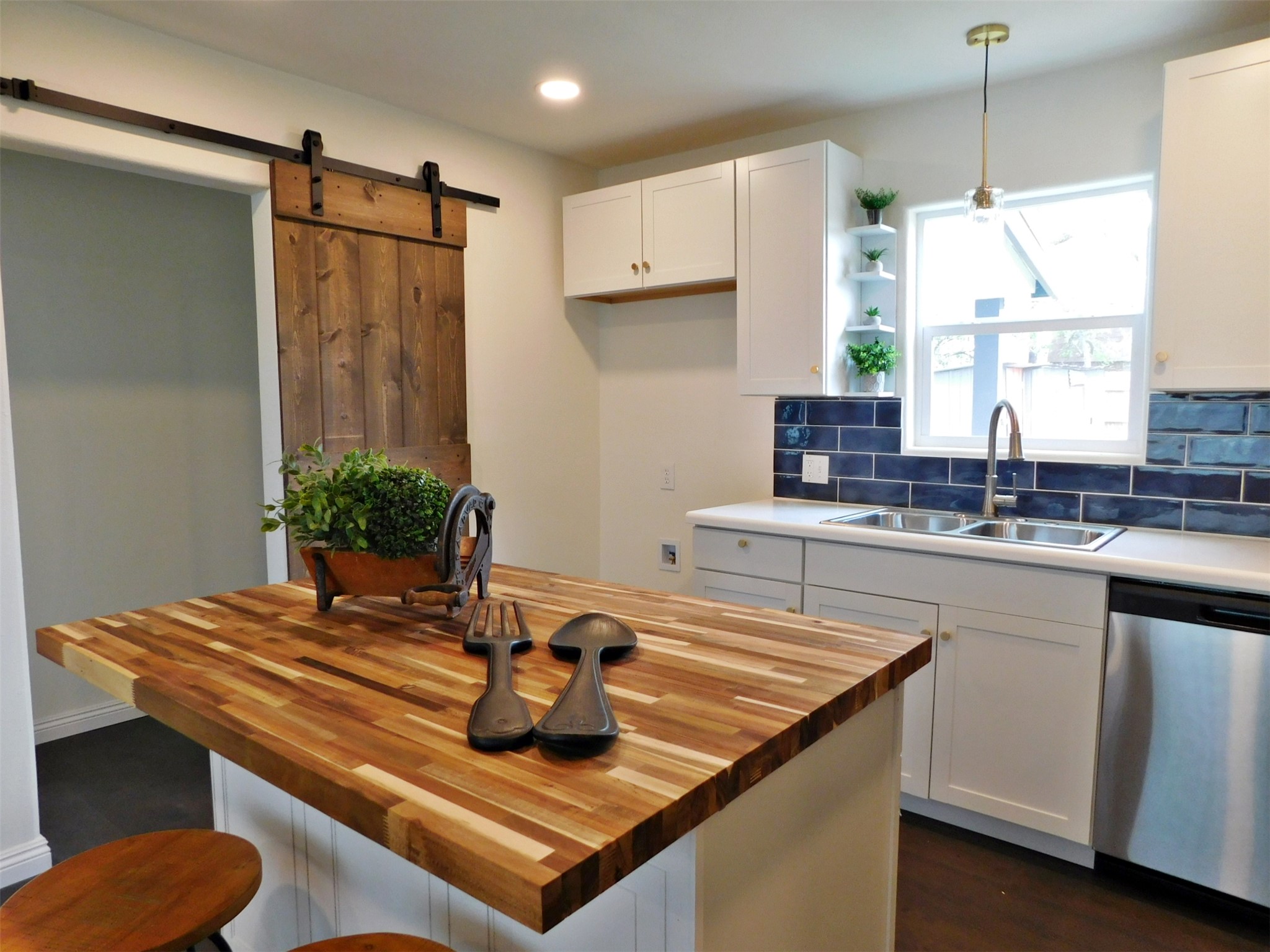 205 East Train Street Ellinger, TX 78938 - Photo 5 of 27 a kitchen with kitchen island granite countertop a sink and a stove
