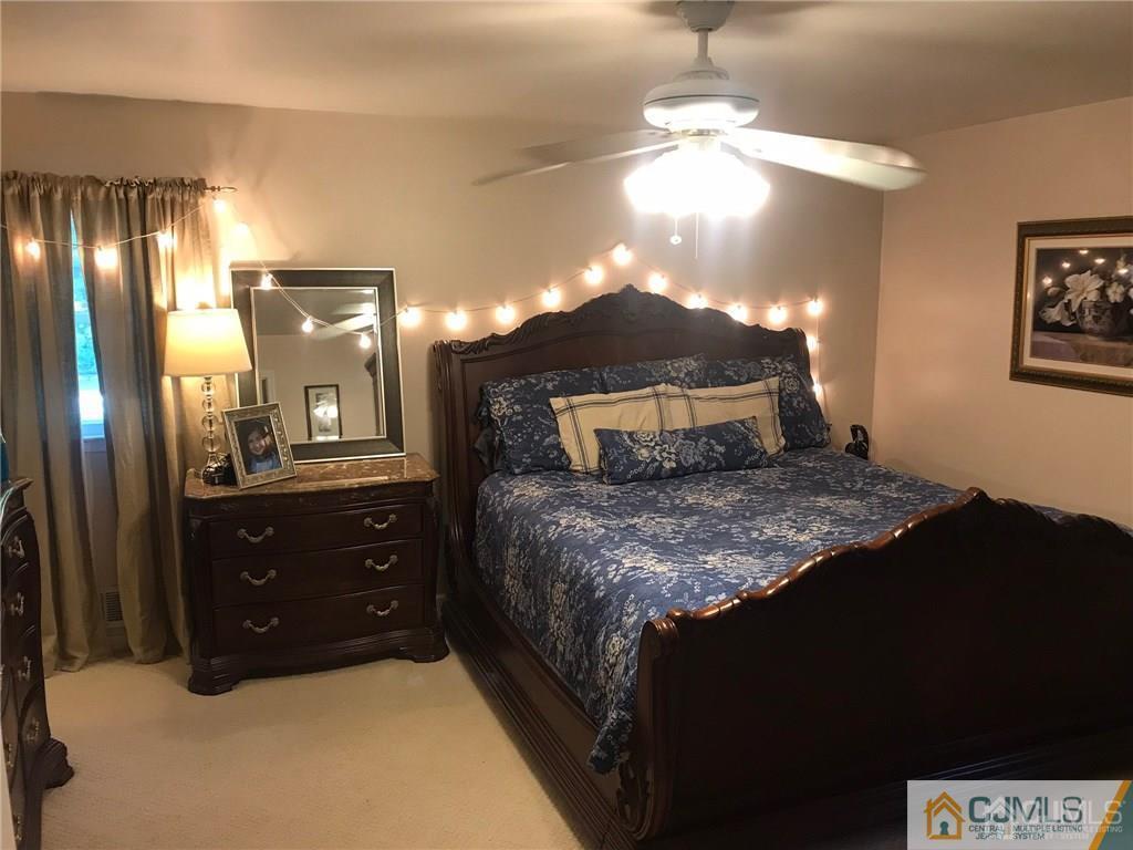 11 Colin Street East Brunswick, NJ 08816 - Photo 17 of 29 a bedroom with a bed and a chandelier