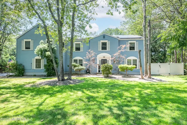 a front view of house with yard and green space