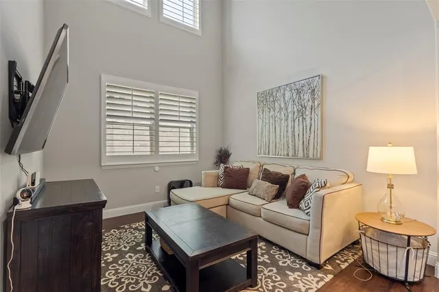 a view of a workspace with furniture and a bookshelf