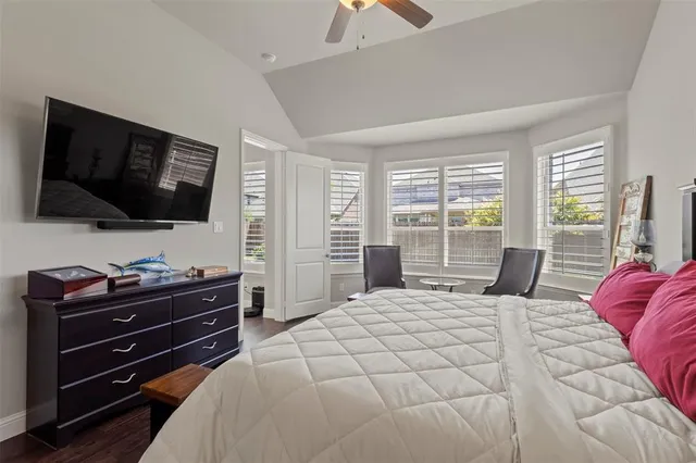 a bedroom with a bed a lamp and a large window