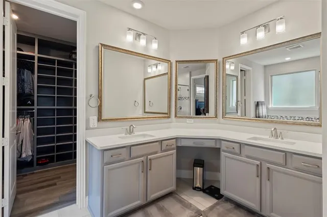 a spacious bathroom with a granite countertop sink and a mirror