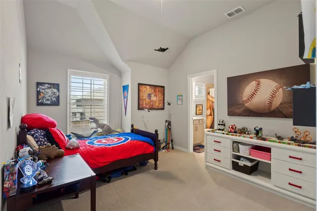 a bedroom with furniture and a flat screen tv