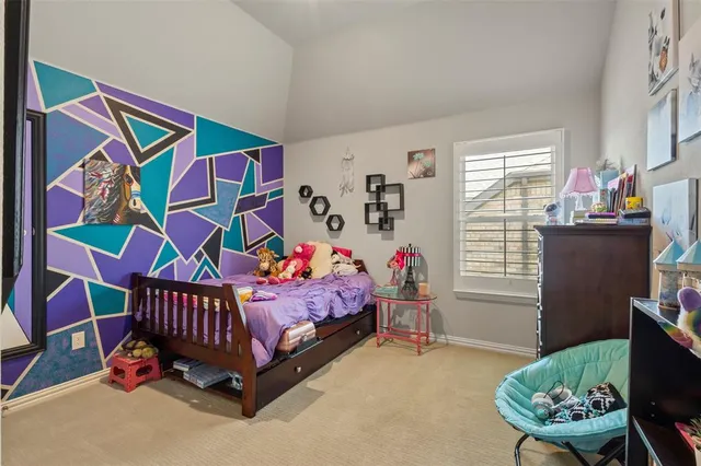 a bedroom with a bed and a large mirror