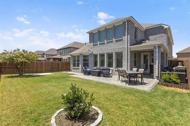 a view of a chairs and table in patio with wooden fence