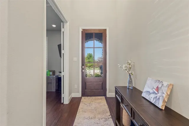 a hallway with furniture and wooden floor