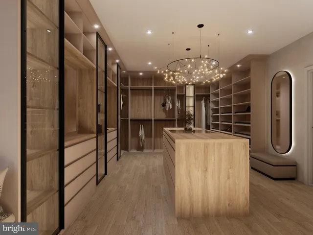 a view of a hallway with wooden floor and chandelier