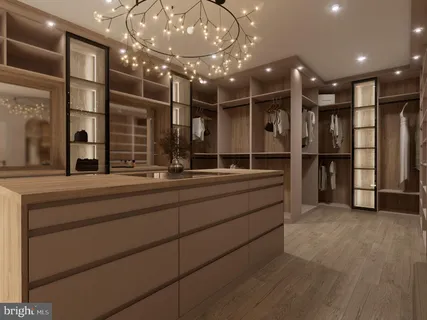 a kitchen with stainless steel appliances a large counter top a stove and a refrigerator