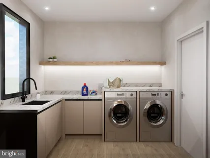 a utility room with cabinets dryer and washer