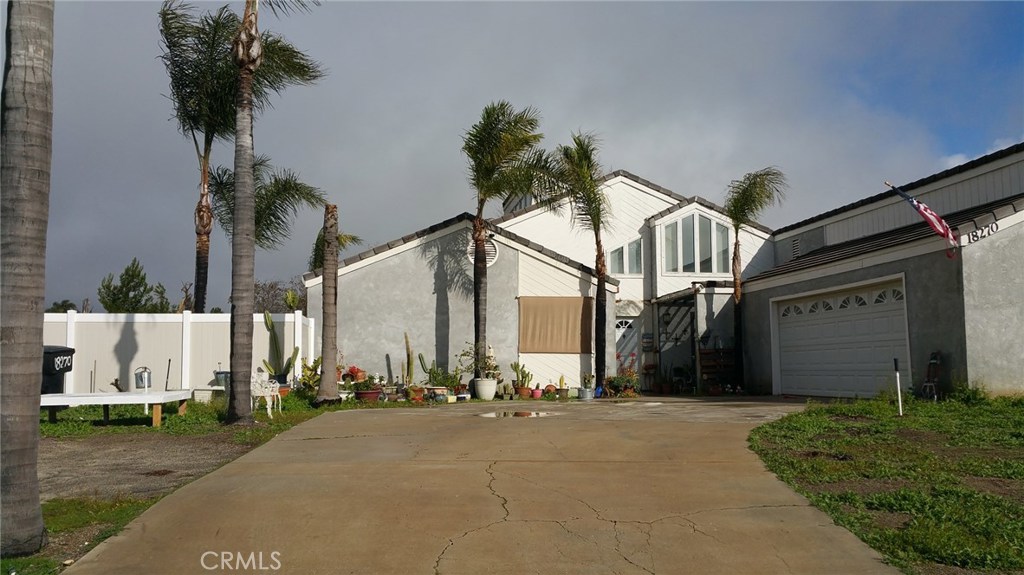 18270 Newman Avenue Riverside, CA 92508 - Photo 1 of 1 a front view of a house with a yard and garage