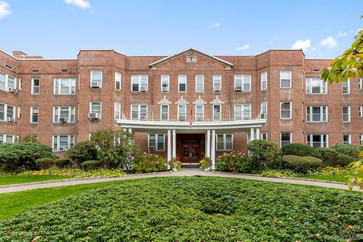 2 Overlook Road, Unit 1B7A White Plains, NY 10605 - Photo 1 of 18 a front view of a residential apartment building with a yard