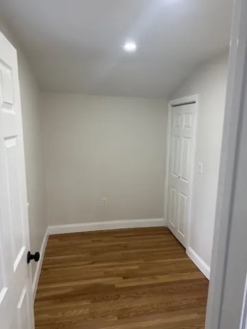 a view of room with wooden floor