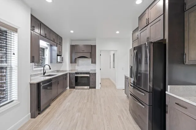 a large room with a large window and stainless steel appliances