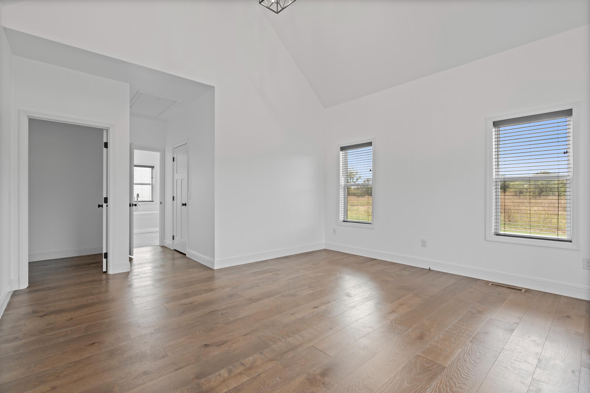 28 Henderson Road Lynchburg, TN 37352 - Photo 17 of 50 an empty room with wooden floor and windows