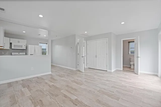 a kitchen with white cabinets and white appliances
