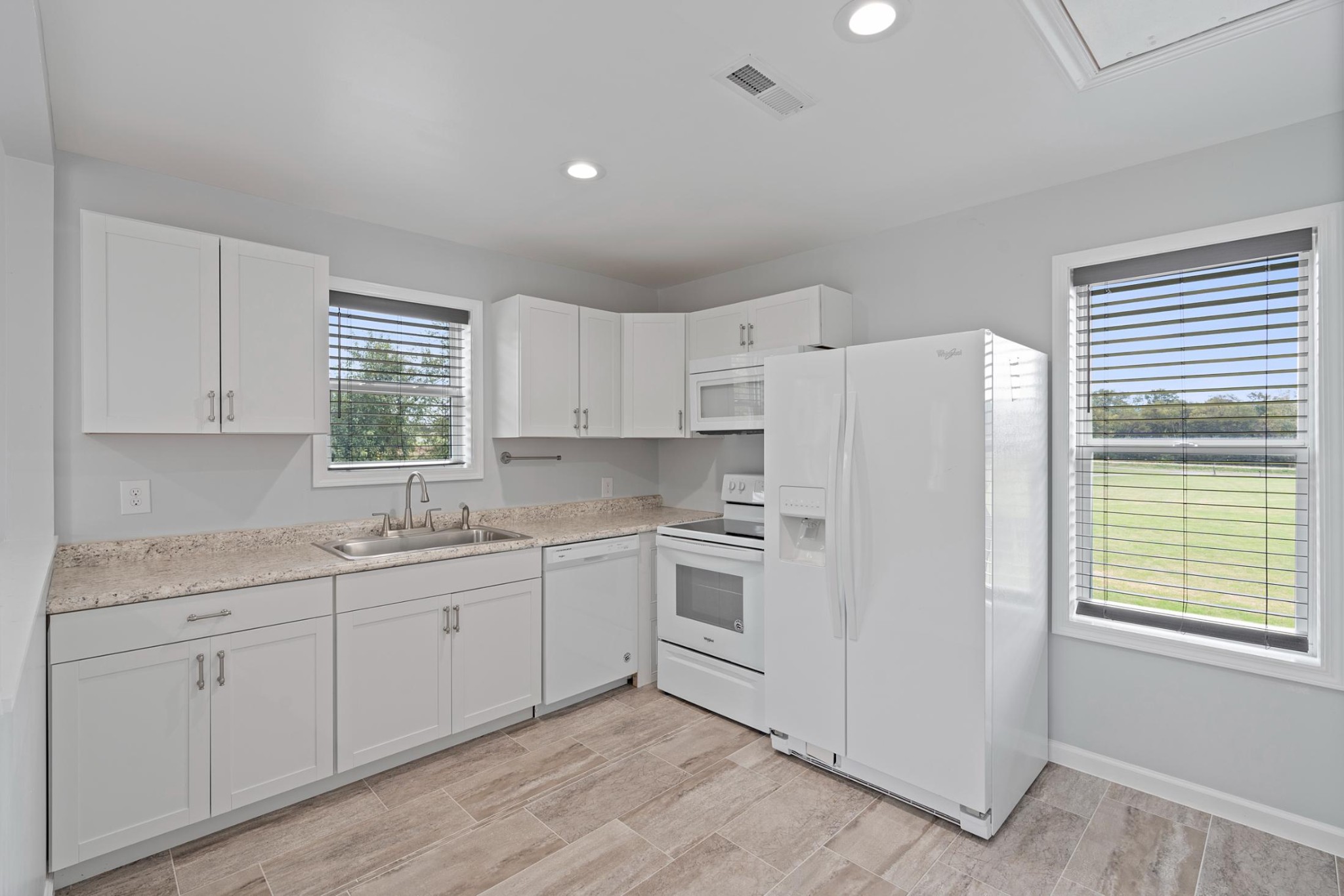 28 Henderson Road Lynchburg, TN 37352 - Photo 34 of 50 a kitchen with white cabinets and white appliances