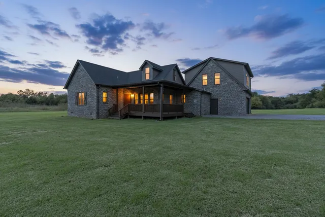 an aerial view of a house with porch yard basket ball court and trampoline
