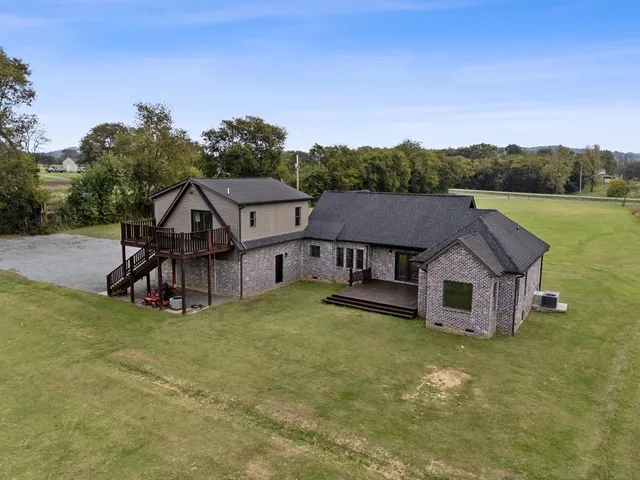 an aerial view of residential houses with outdoor space and mountain view