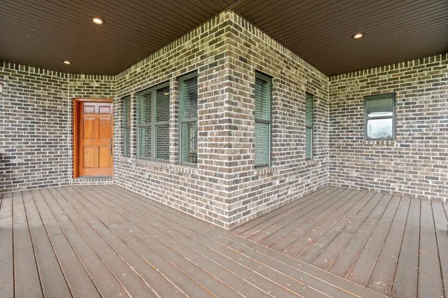 a view of a balcony with wooden floor
