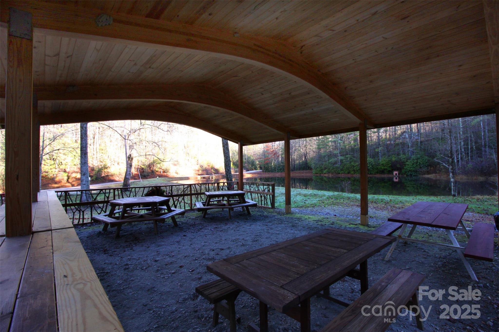 Lot 16 Arrowhead Ridge, Unit 16R Brevard, NC 28712 - Photo 14 of 18 a view of a patio with table and chairs and wooden floor