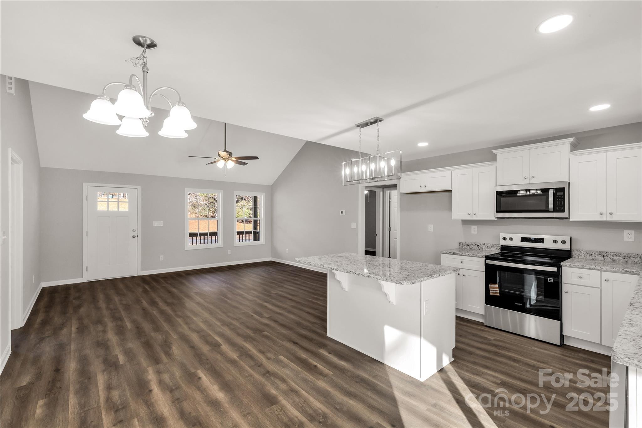 970 Helms Street Rock Hill, SC 29732 - Photo 19 of 32 a kitchen with stainless steel appliances kitchen island granite countertop a stove a sink and a refrigerator