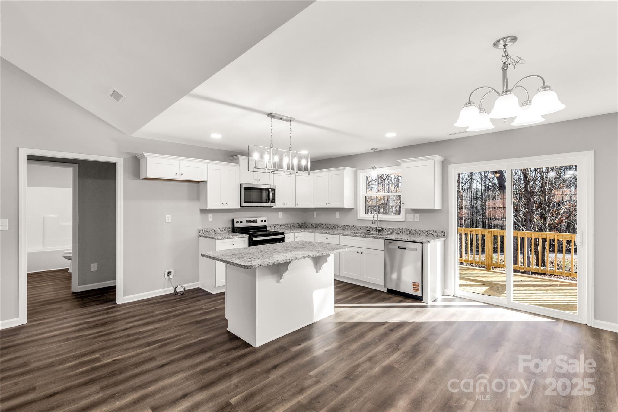 970 Helms Street Rock Hill, SC 29732 - Photo 20 of 32 a kitchen with stainless steel appliances a stove a sink dishwasher a refrigerator white cabinets wooden floor and a fireplace