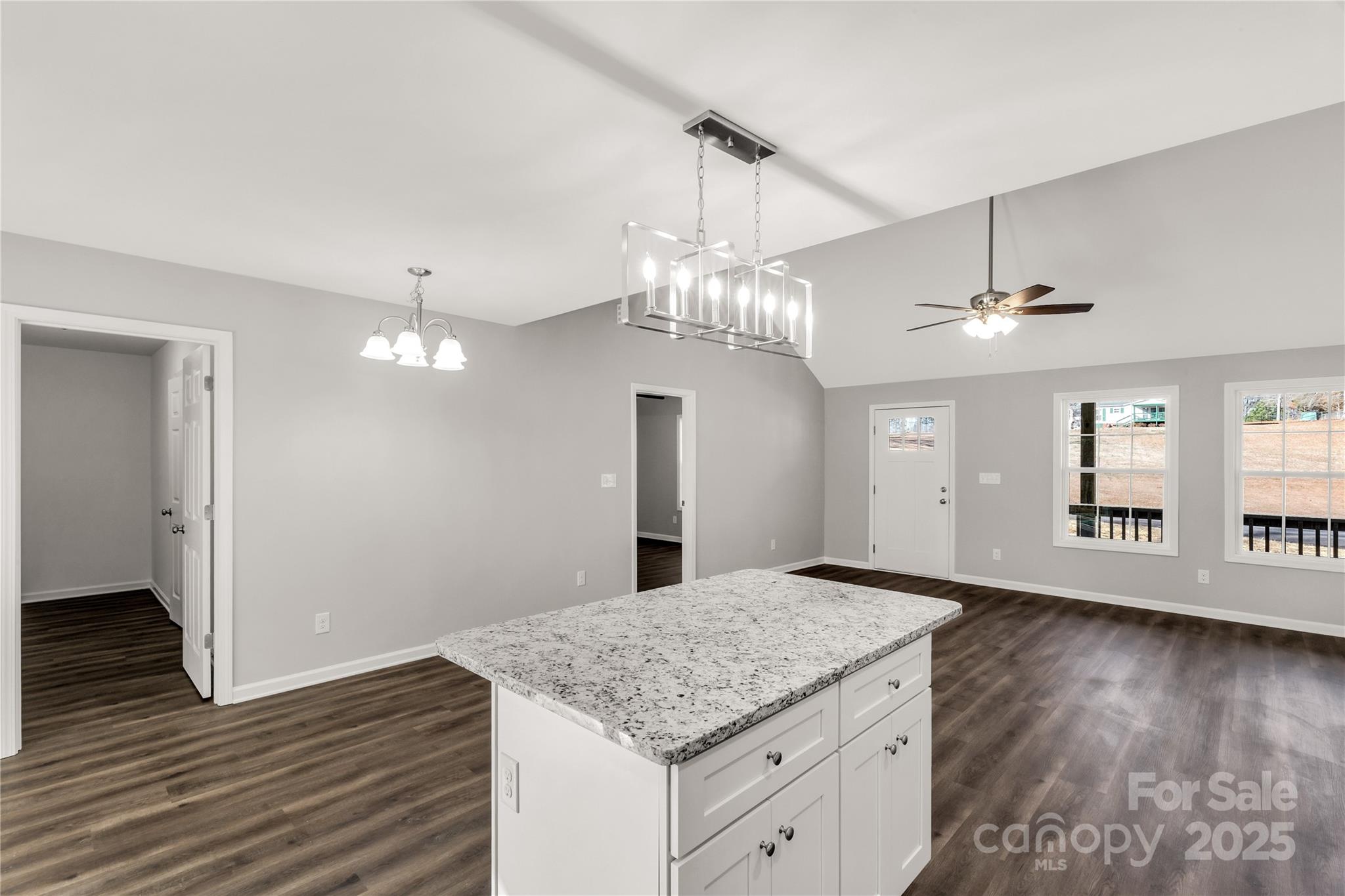 970 Helms Street Rock Hill, SC 29732 - Photo 22 of 32 an empty room with wooden floor chandelier and kitchen view