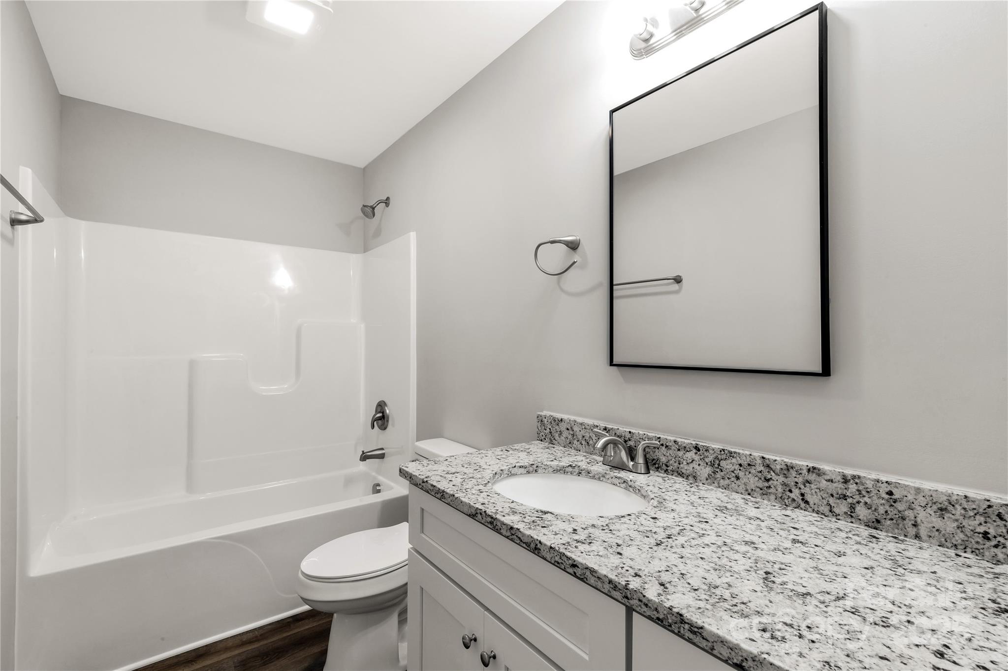 970 Helms Street Rock Hill, SC 29732 - Photo 30 of 32 a bathroom with a granite countertop sink toilet mirror and bathtub