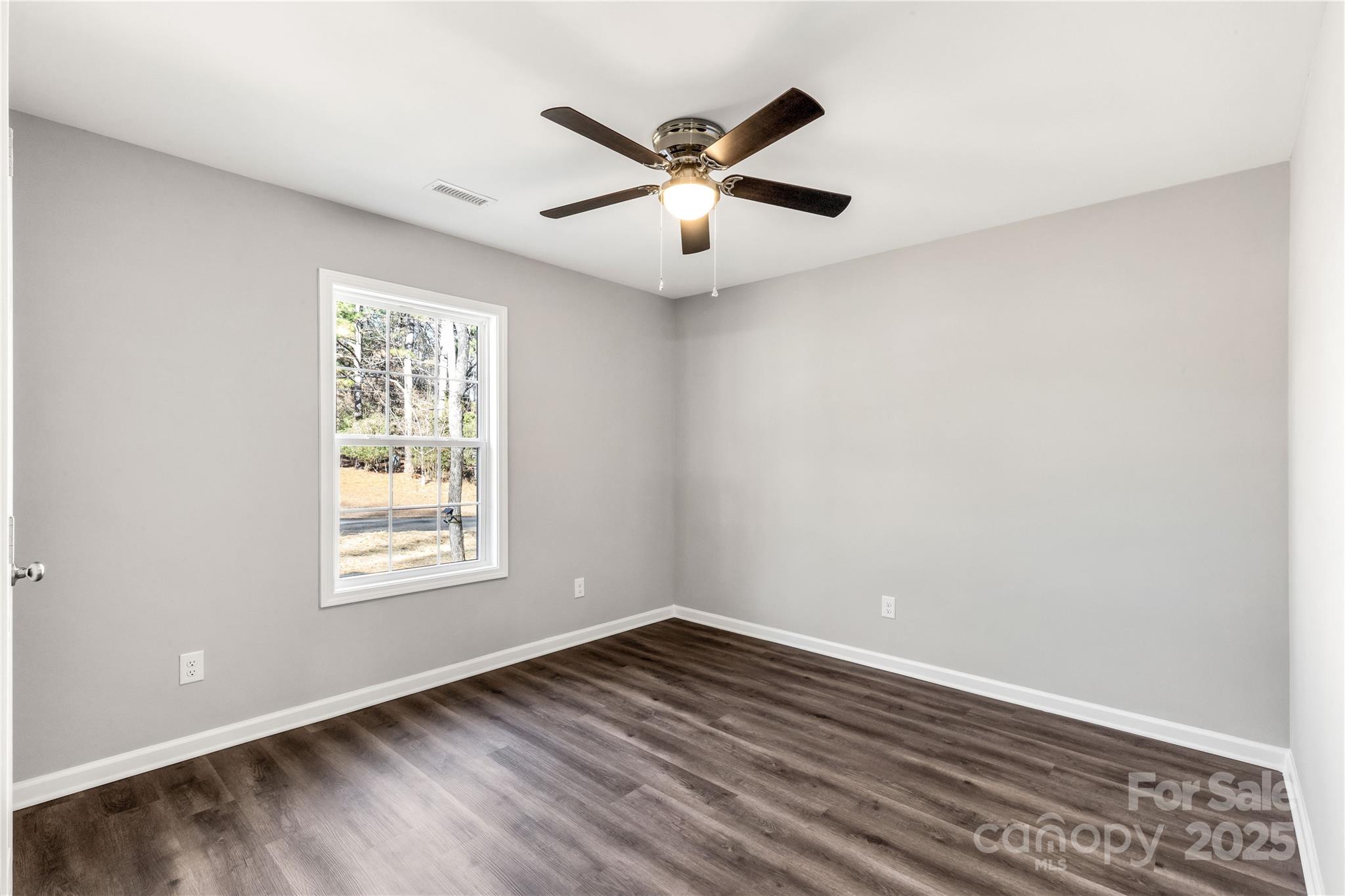 970 Helms Street Rock Hill, SC 29732 - Photo 31 of 32 an empty room with wooden floor and windows