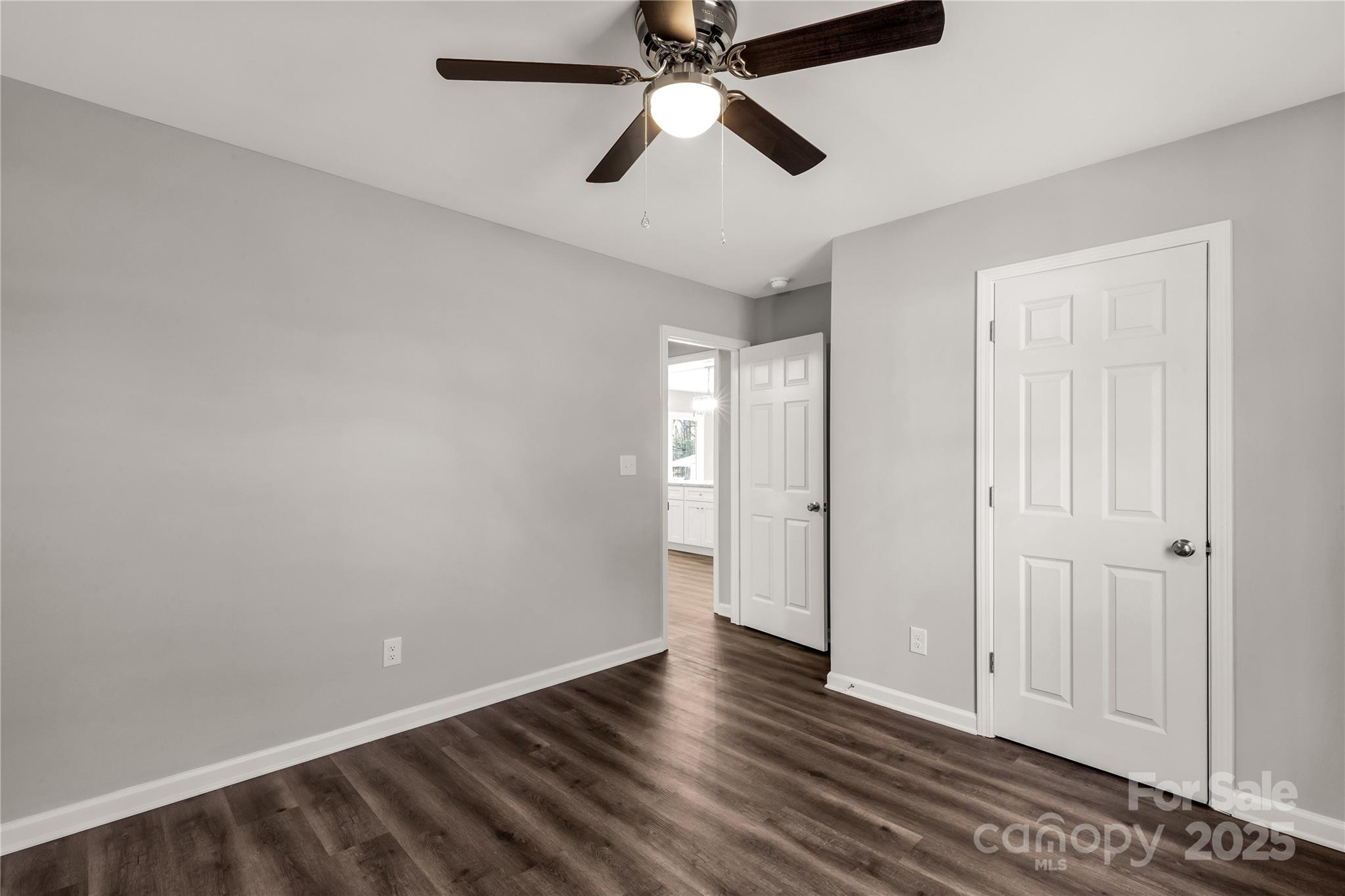 970 Helms Street Rock Hill, SC 29732 - Photo 32 of 32 an empty room with wooden floor ceiling fan and windows