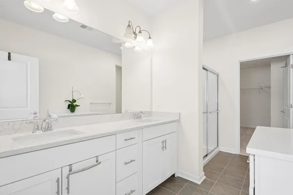 a bathroom with a double vanity sink and mirror