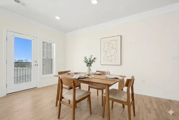 a view of a dining room with furniture and wooden floor