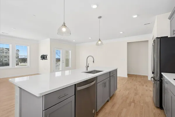 a kitchen with a sink center island and stainless steel appliances