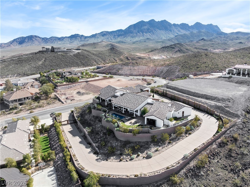 1123 Christian Road Henderson, NV 89002 - Photo 88 of 94 Perched on a mountainside, this expansive desert estate boasts a private pool and winding driveway.