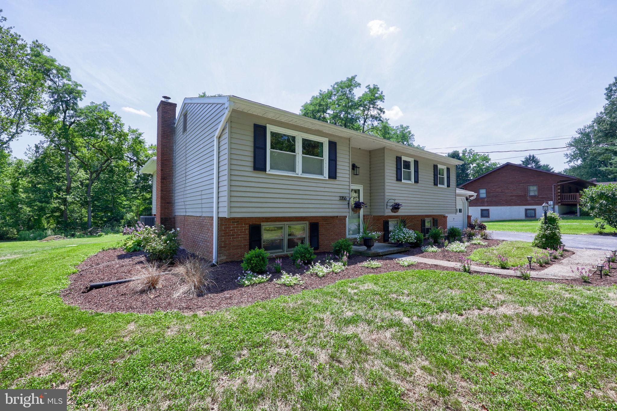 Charming split-level home with lush greenery.