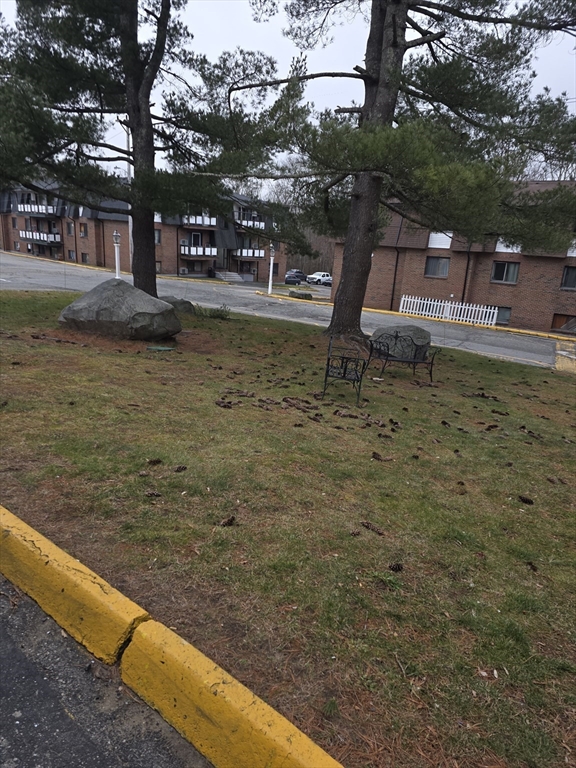 103 Hart Street, Unit 5206 Taunton, MA 02780 - Photo 2 of 9 a view of swimming pool with lawn chairs and wooden fence