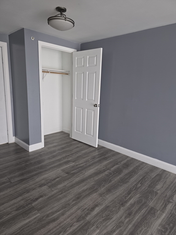 103 Hart Street, Unit 5206 Taunton, MA 02780 - Photo 8 of 9 a view of an empty room with wooden floor