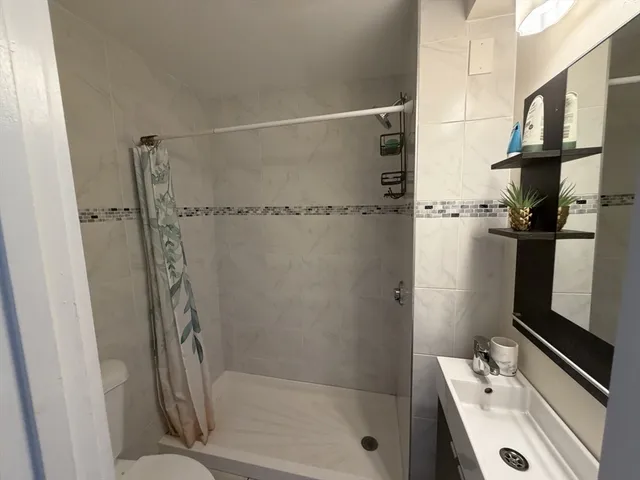 a bathroom with a tub and a shower