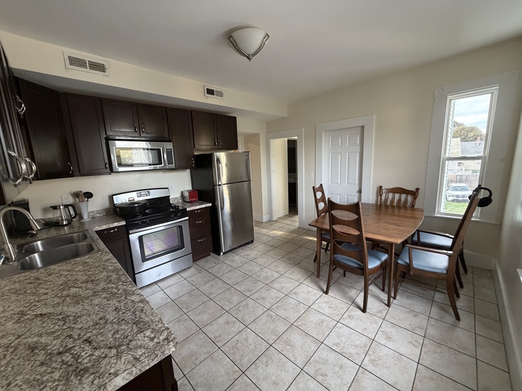 11 Francis Street, Unit 2 Malden, MA 02148 - Photo 2 of 12 a kitchen with stainless steel appliances kitchen island granite countertop a sink and cabinets