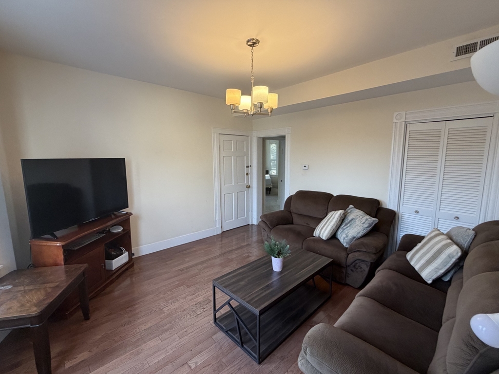 11 Francis Street, Unit 2 Malden, MA 02148 - Photo 6 of 12 a living room with furniture a flat screen tv and a chandelier