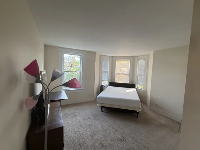 a bed room with a bed and a window