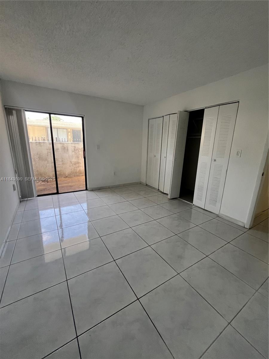 7430 Southwest 153rd Place, Unit 1061 Miami, FL 33193 - Photo 11 of 42 a view of a livingroom with an empty space and window