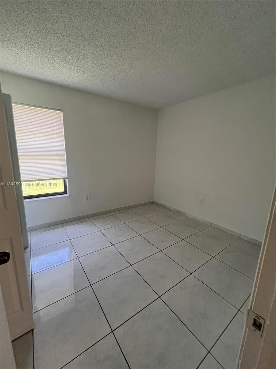 7430 Southwest 153rd Place, Unit 1061 Miami, FL 33193 - Photo 12 of 42 a view of an empty room and a window