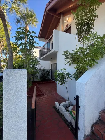 a view of a patio with chair and potted plants