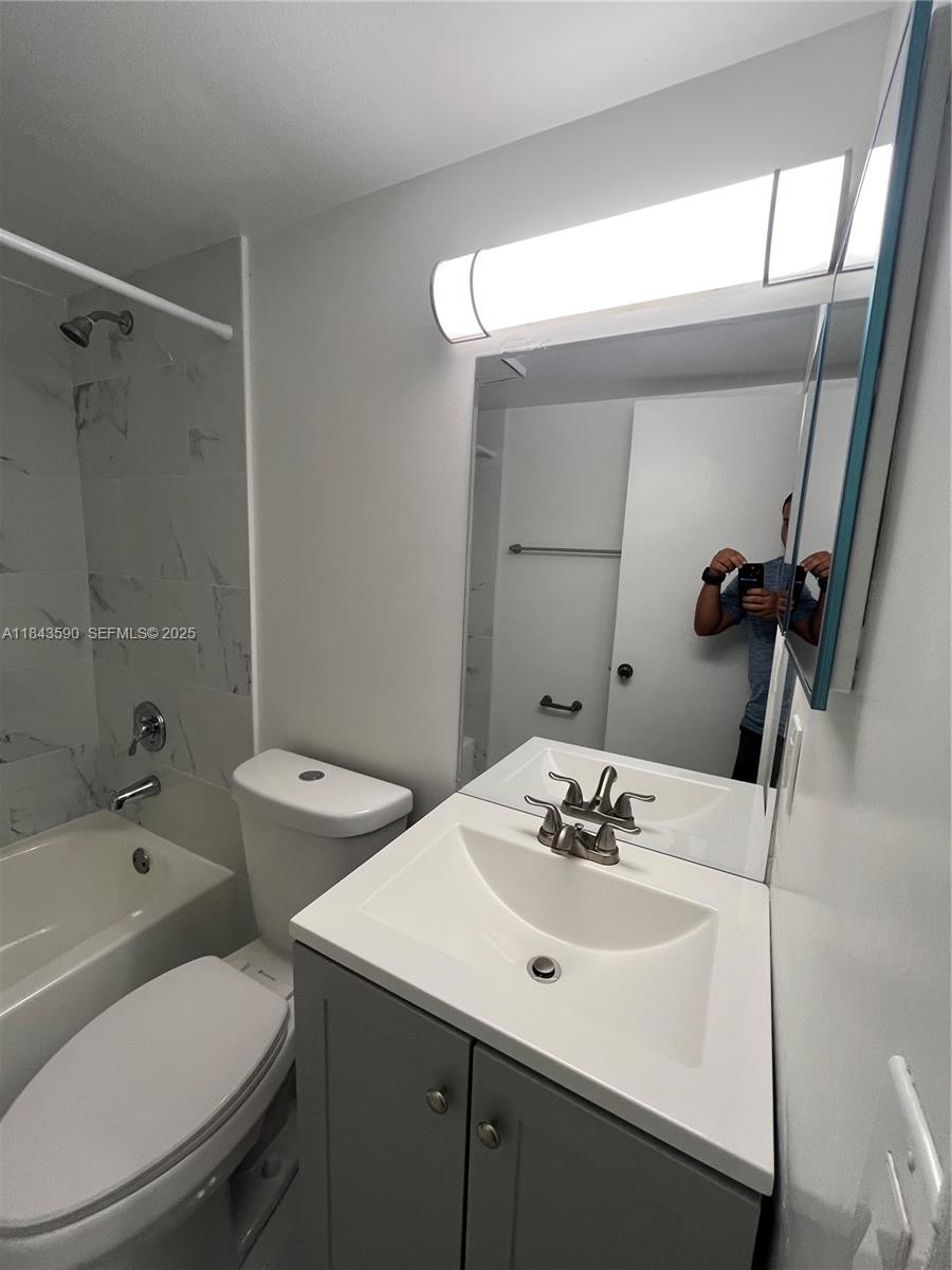 7430 Southwest 153rd Place, Unit 1061 Miami, FL 33193 - Photo 16 of 42 a bathroom with a sink toilet and shower