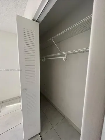 a bathroom with a sink a toilet a mirror and shower