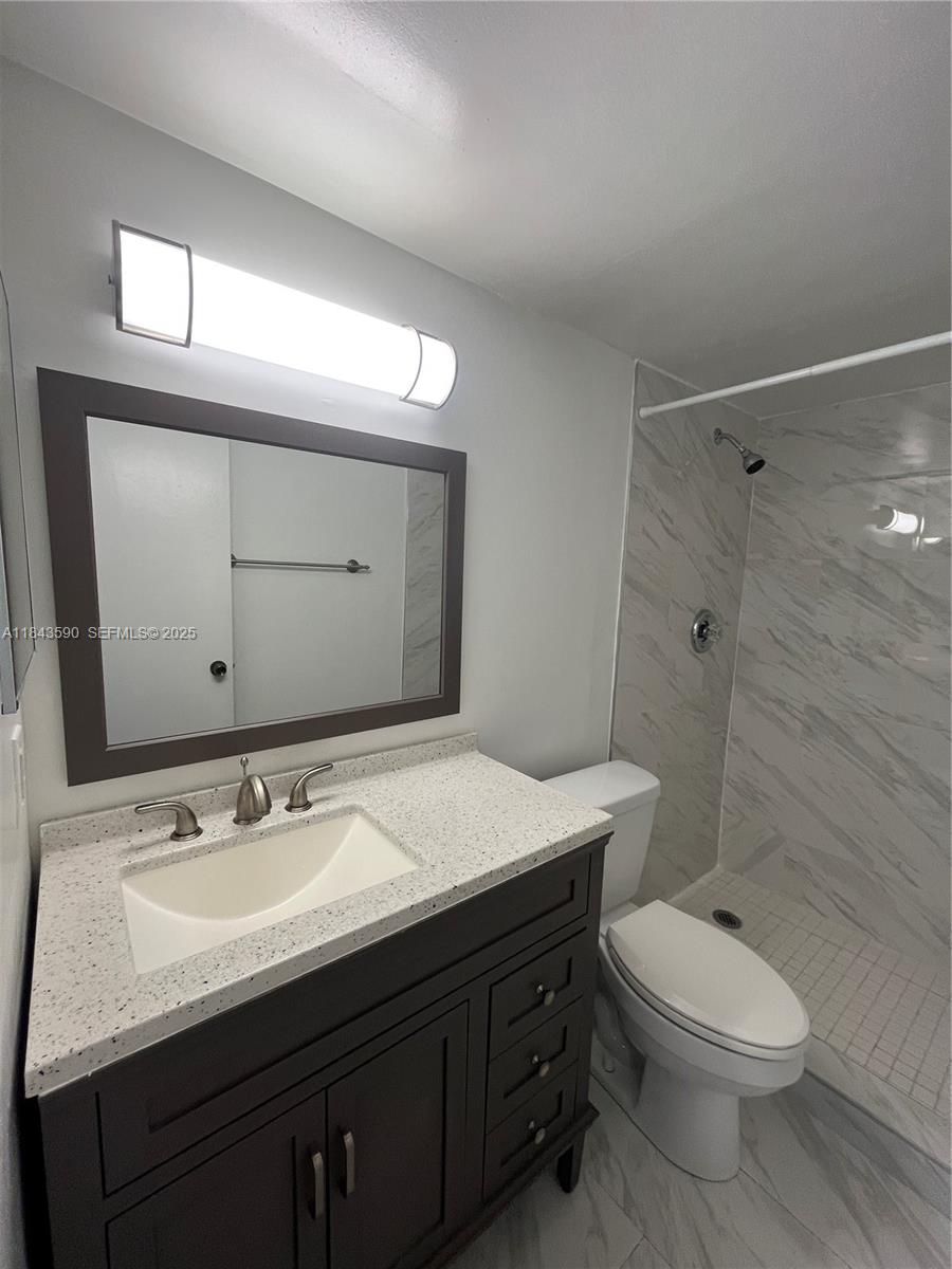 7430 Southwest 153rd Place, Unit 1061 Miami, FL 33193 - Photo 20 of 42 a bathroom with a sink a toilet and shower